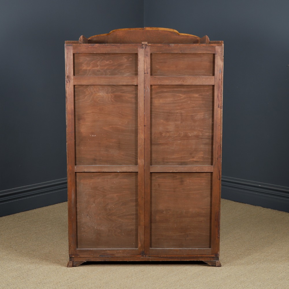 An Art Deco two door wardrobe crafted from warm brown figured walnut veneer with a gently curved bow front and wooden vertical handles. View XIV