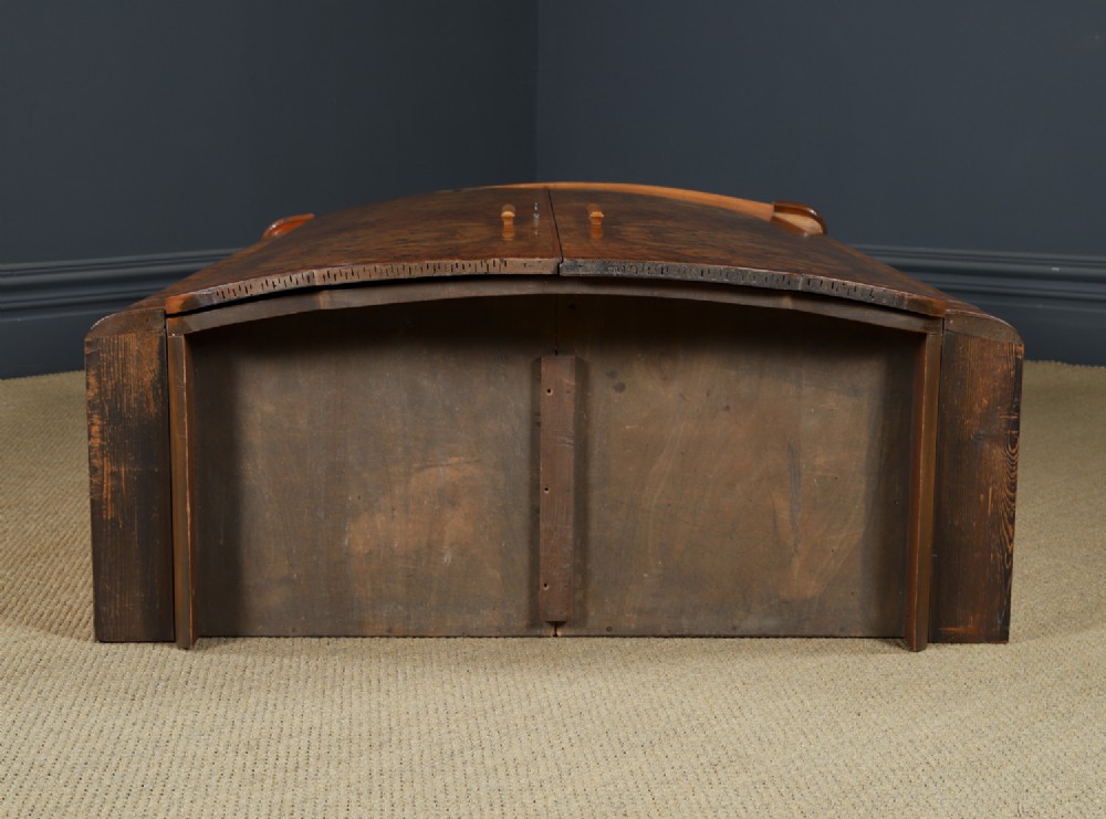 An Art Deco two door wardrobe crafted from warm brown figured walnut veneer with a gently curved bow front and wooden vertical handles. View XV
