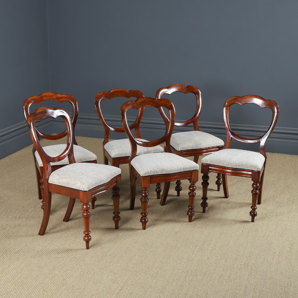 A set of six Victorian mahogany dining chairs featuring open balloon-shaped backs, turned front legs, and neutral upholstered seats. View II