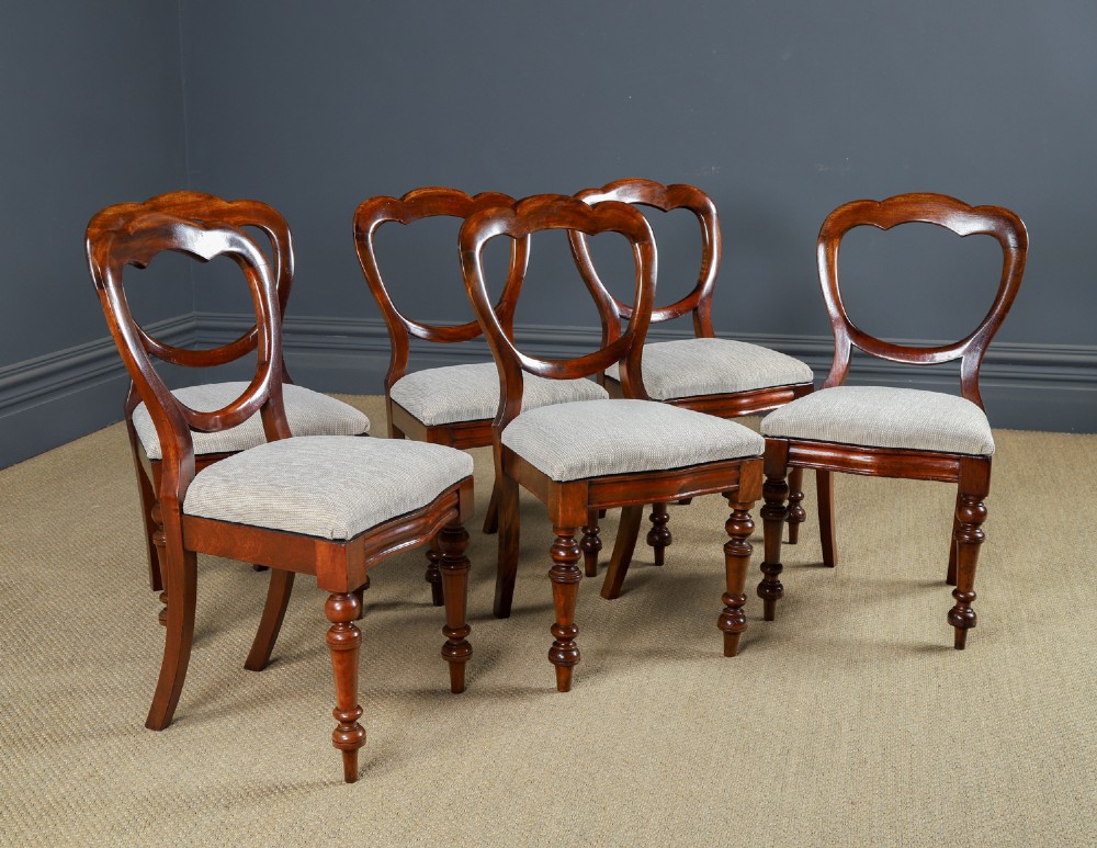 A set of six Victorian mahogany dining chairs featuring open balloon-shaped backs, turned front legs, and neutral upholstered seats. View III