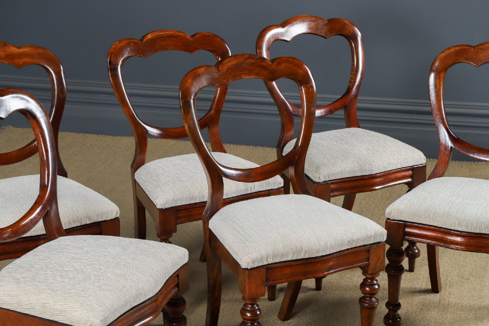 A set of six Victorian mahogany dining chairs featuring open balloon-shaped backs, turned front legs, and neutral upholstered seats. View IV