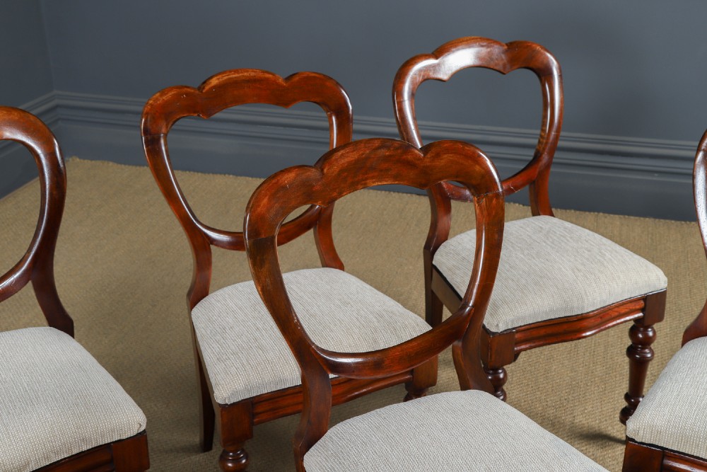 A set of six Victorian mahogany dining chairs featuring open balloon-shaped backs, turned front legs, and neutral upholstered seats. View VIII