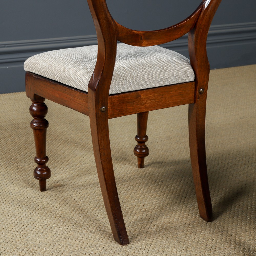 A set of six Victorian mahogany dining chairs featuring open balloon-shaped backs, turned front legs, and neutral upholstered seats. View IX