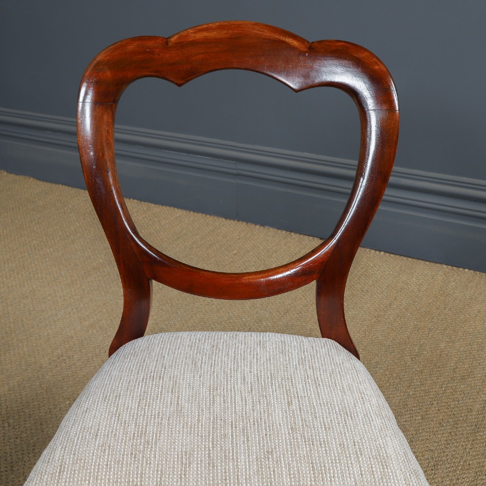 A set of six Victorian mahogany dining chairs featuring open balloon-shaped backs, turned front legs, and neutral upholstered seats. View XI