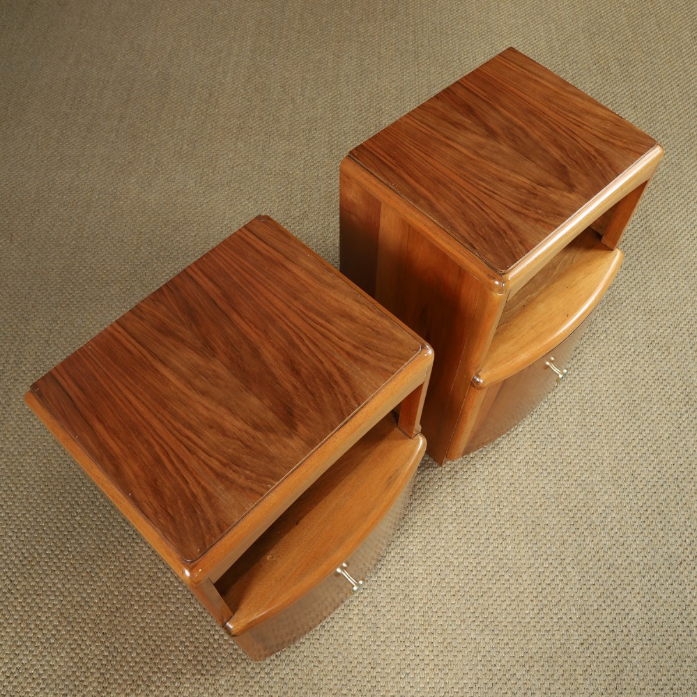 A pair of Art Deco walnut bedside tables with an upper open compartment and a lower cupboard featuring a round green handle. View VI