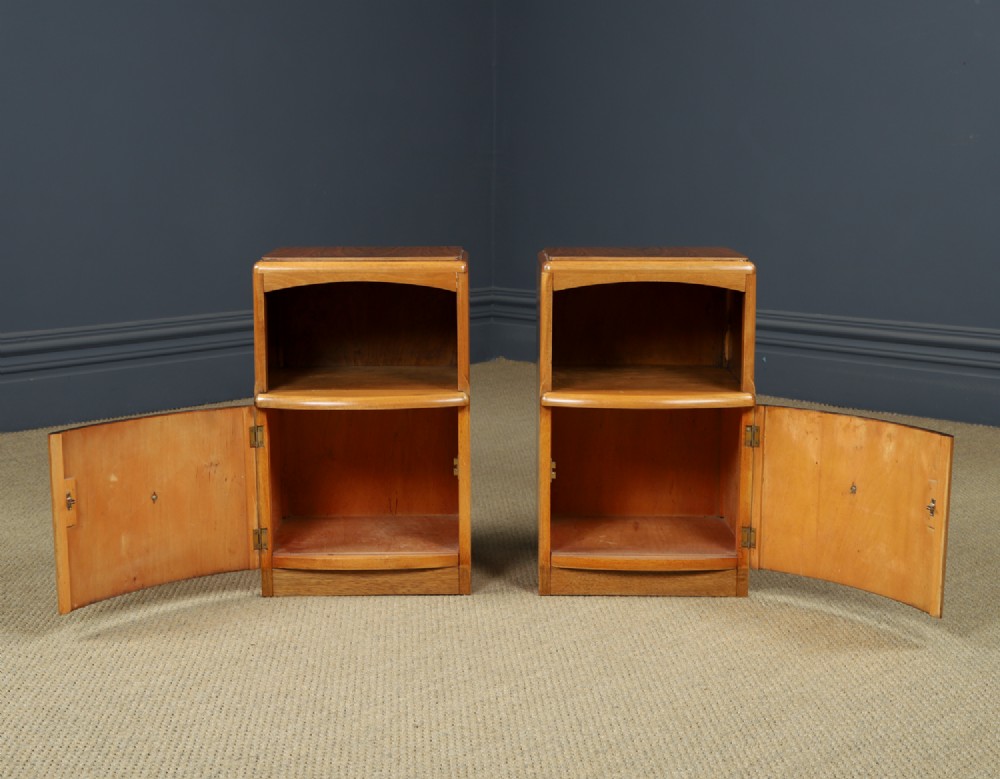 A pair of Art Deco walnut bedside tables with an upper open compartment and a lower cupboard featuring a round green handle. View VII