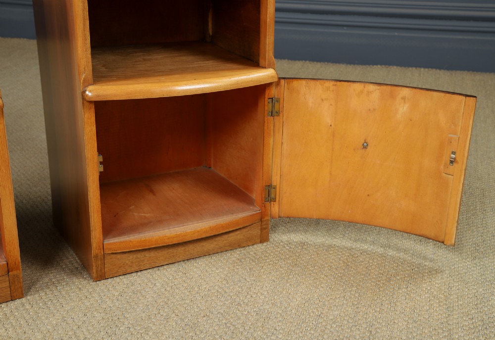A pair of Art Deco walnut bedside tables with an upper open compartment and a lower cupboard featuring a round green handle. View VIII