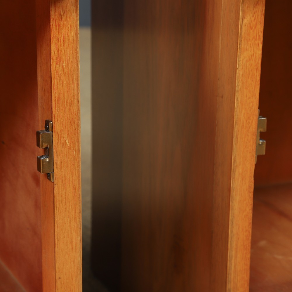 A pair of Art Deco walnut bedside tables with an upper open compartment and a lower cupboard featuring a round green handle. View X