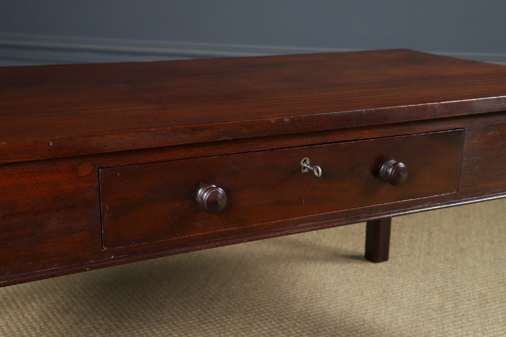 An antique rectangular dark mahogany low coffee table featuring a single drawer with two turned handles and a brass keyhole. View III