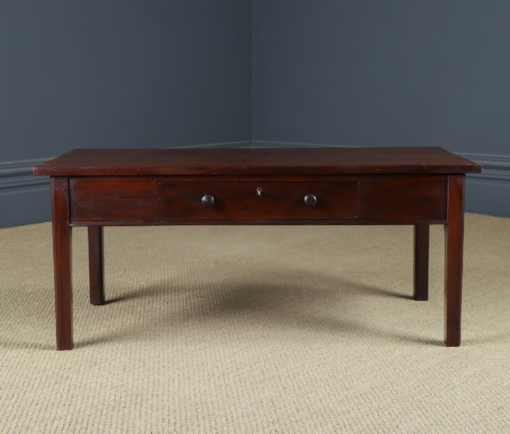 An antique rectangular dark mahogany low coffee table featuring a single drawer with two turned handles and a brass keyhole. View V