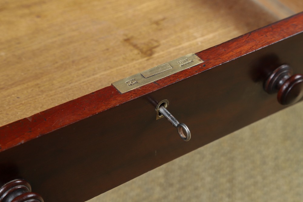 An antique rectangular dark mahogany low coffee table featuring a single drawer with two turned handles and a brass keyhole. View VII