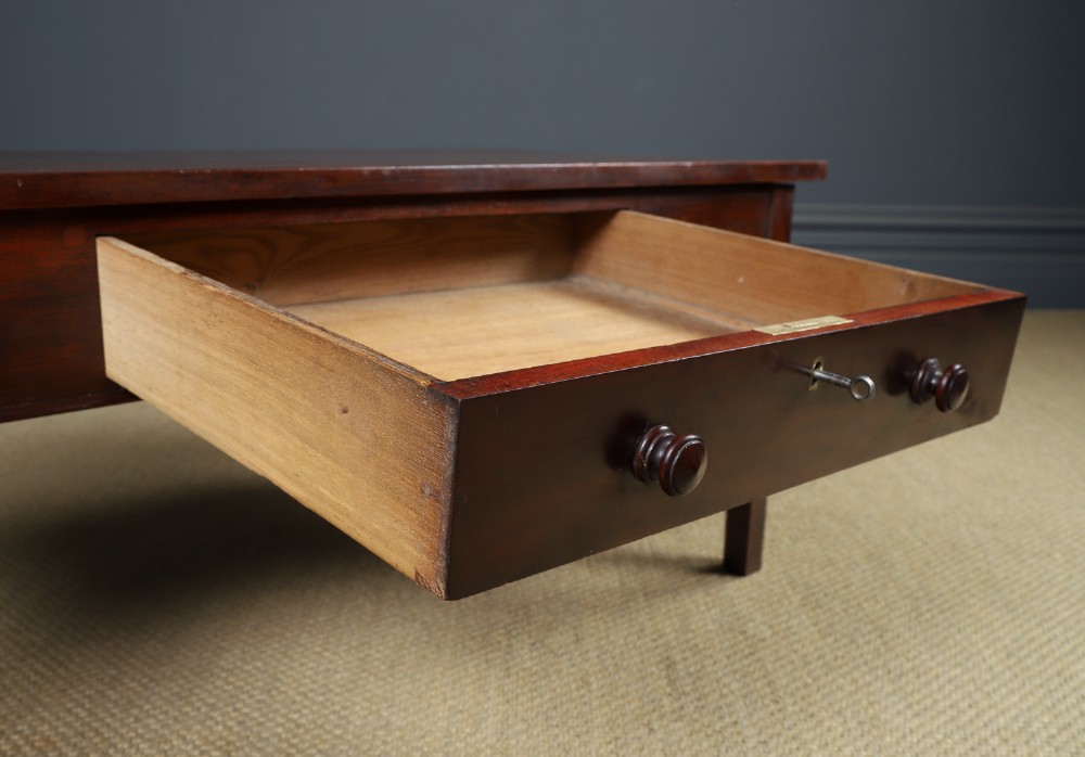 An antique rectangular dark mahogany low coffee table featuring a single drawer with two turned handles and a brass keyhole. View VIII