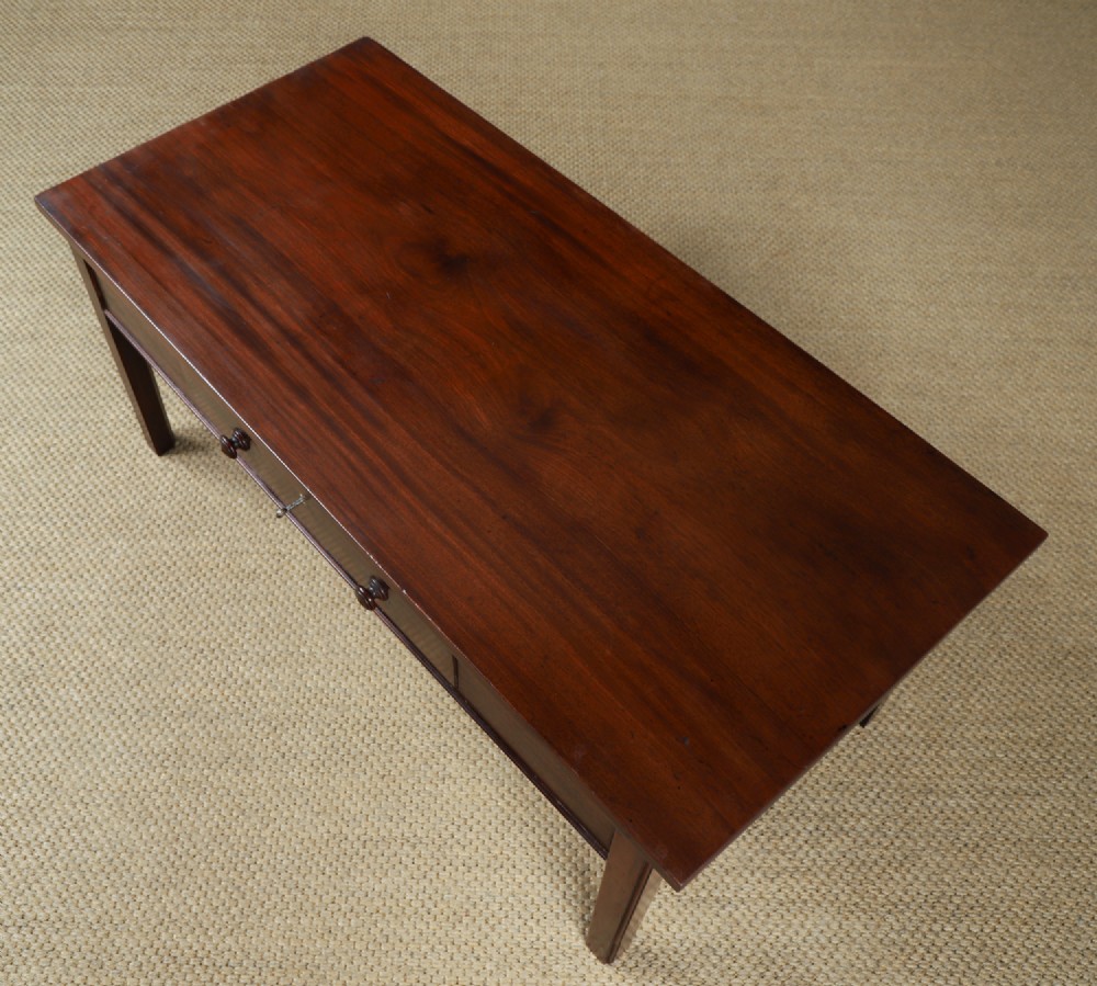 An antique rectangular dark mahogany low coffee table featuring a single drawer with two turned handles and a brass keyhole. View X
