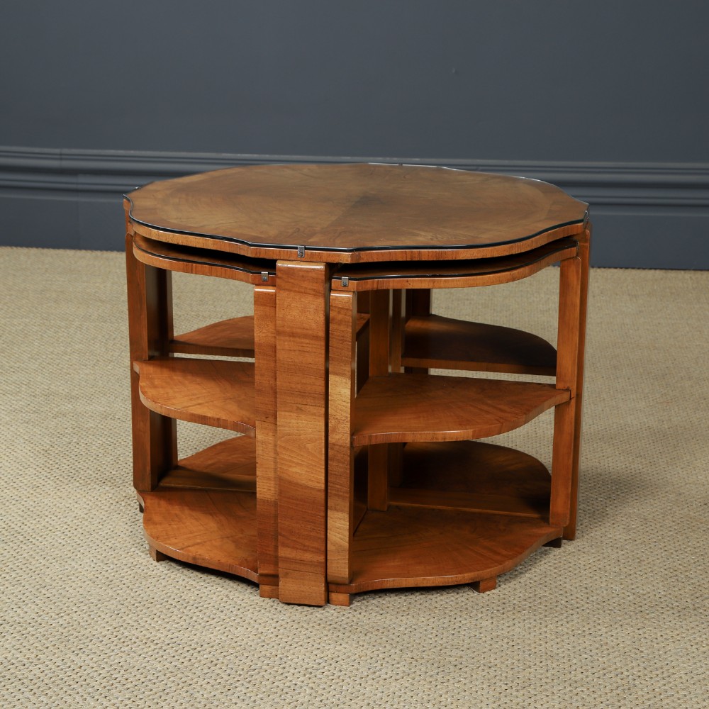 An Art Deco round walnut nest of five occasional tables featuring four quadrant side tables fitted beneath a central coffee table top. View V