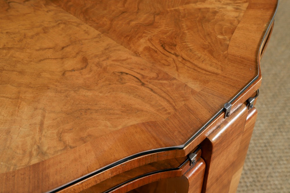 An Art Deco round walnut nest of five occasional tables featuring four quadrant side tables fitted beneath a central coffee table top. View VI