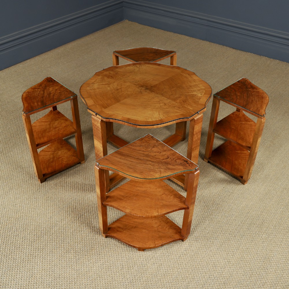 An Art Deco round walnut nest of five occasional tables featuring four quadrant side tables fitted beneath a central coffee table top. View VII