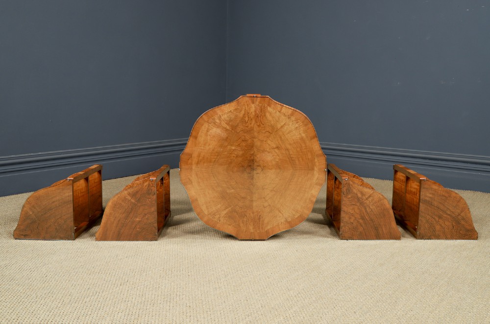 An Art Deco round walnut nest of five occasional tables featuring four quadrant side tables fitted beneath a central coffee table top. View XI