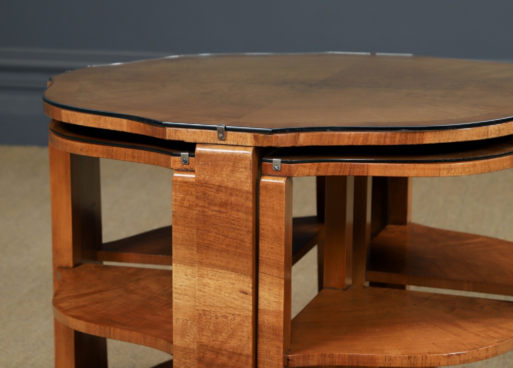 An Art Deco round walnut nest of five occasional tables featuring four quadrant side tables fitted beneath a central coffee table top. View XIV