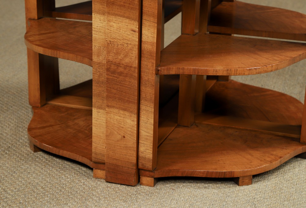An Art Deco round walnut nest of five occasional tables featuring four quadrant side tables fitted beneath a central coffee table top. View XV