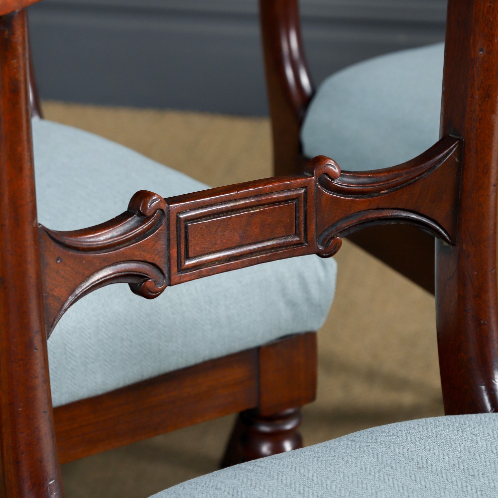A set of six antique mahogany dining chairs featuring curved top rails, carved horizontal splats, fluted turned front legs, and light blue upholstered seats. View IV