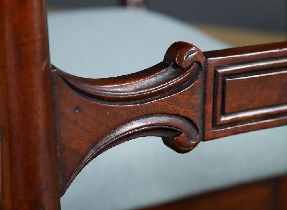 A set of six antique mahogany dining chairs featuring curved top rails, carved horizontal splats, fluted turned front legs, and light blue upholstered seats. View V