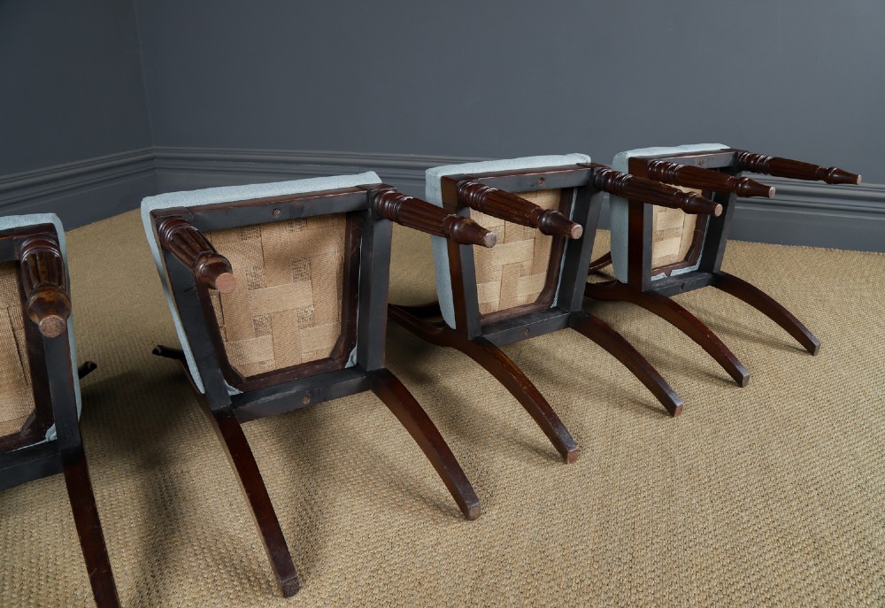 A set of six antique mahogany dining chairs featuring curved top rails, carved horizontal splats, fluted turned front legs, and light blue upholstered seats. View XIII