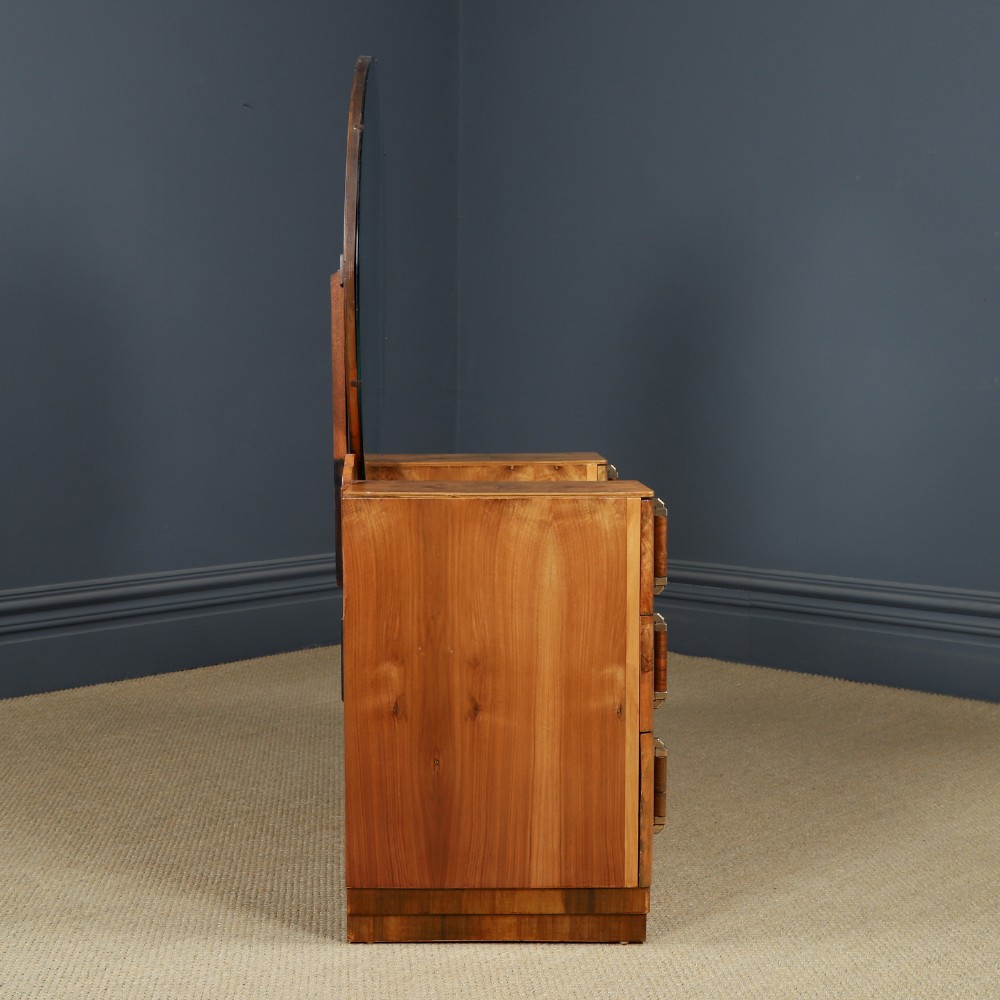 An Art Deco burr walnut pedestal dressing table featuring a large circular central mirror, a kneehole drawer, and three stacked drawers on each pedestal with vertical handles. View XI