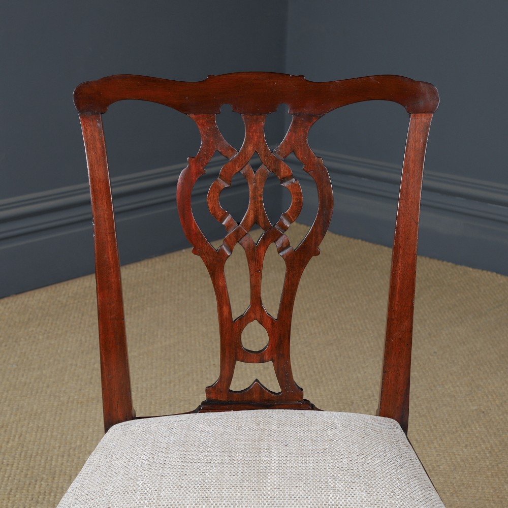 A Georgian mahogany side chair with a pierced carved back splat, square legs connected by stretchers, and a neutral textured seat upholstery. View II