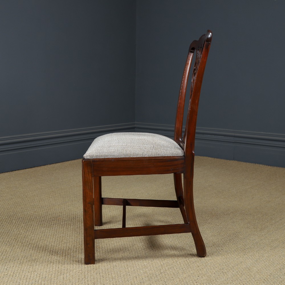 A Georgian mahogany side chair with a pierced carved back splat, square legs connected by stretchers, and a neutral textured seat upholstery. View VII
