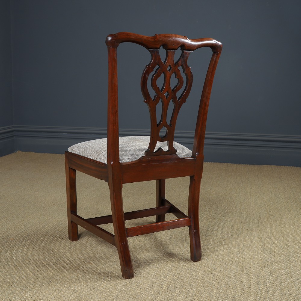 A Georgian mahogany side chair with a pierced carved back splat, square legs connected by stretchers, and a neutral textured seat upholstery. View IX