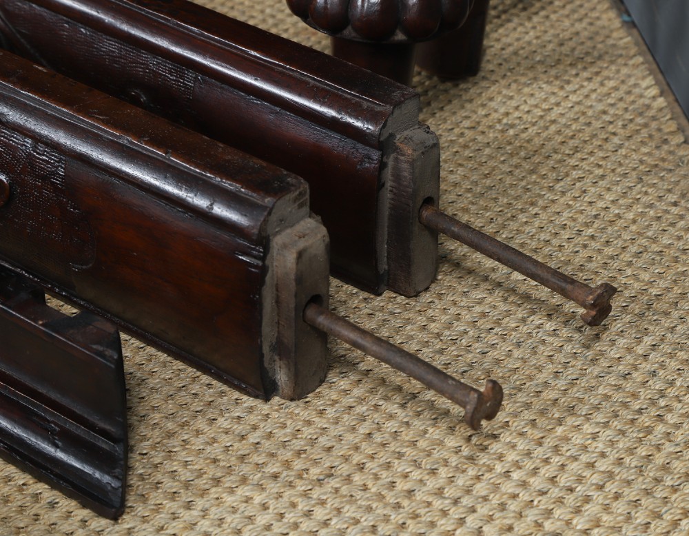 An Anglo-Indian mahogany four poster bed featuring carved turned posts, an ornate headboard, and a spindle footboard. View XV