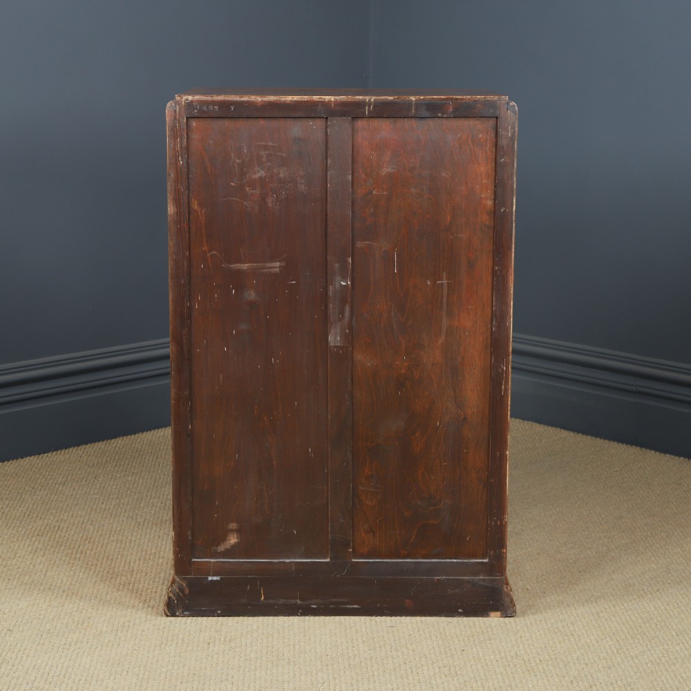 An Art Deco chest of drawers in figured burr walnut featuring six graduated drawers with turned wooden handles and carved shoulder details. View XIV
