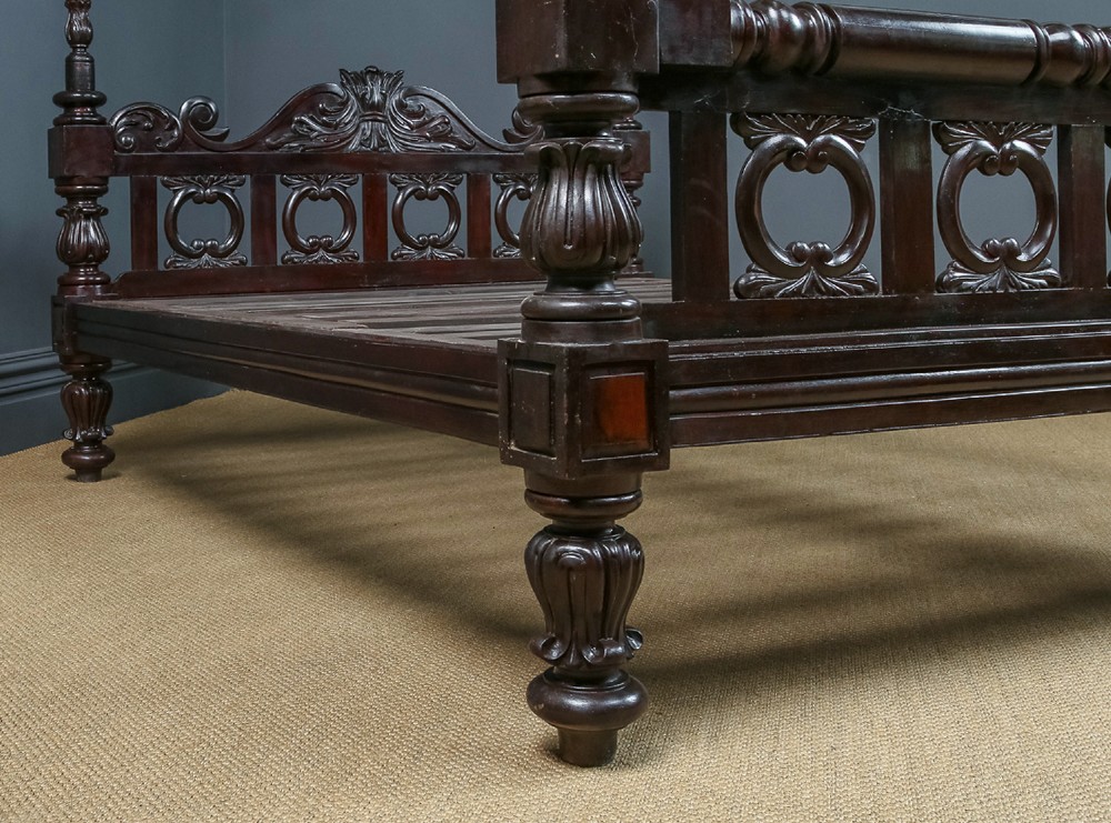An antique dark timber king-size four-poster bed featuring spiral turned posts, a carved footboard with circular cut-out details, and an upper canopy frame. View VIII