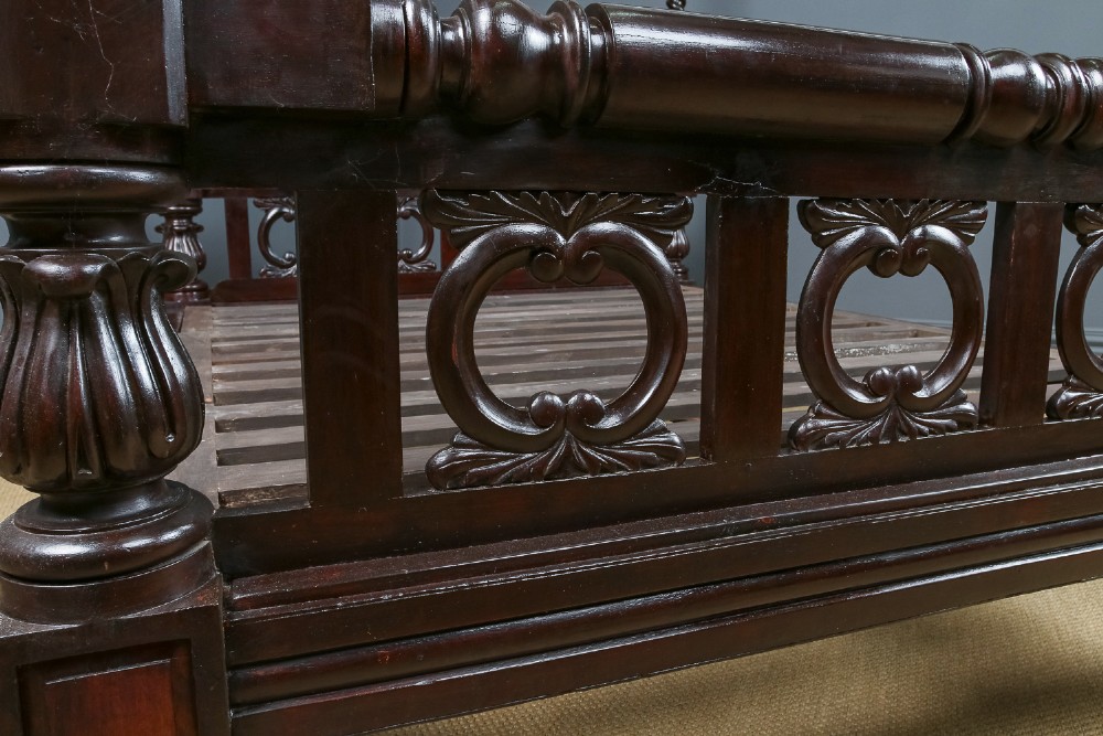 An antique dark timber king-size four-poster bed featuring spiral turned posts, a carved footboard with circular cut-out details, and an upper canopy frame. View IX