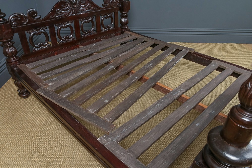 An antique dark timber king-size four-poster bed featuring spiral turned posts, a carved footboard with circular cut-out details, and an upper canopy frame. View XIII