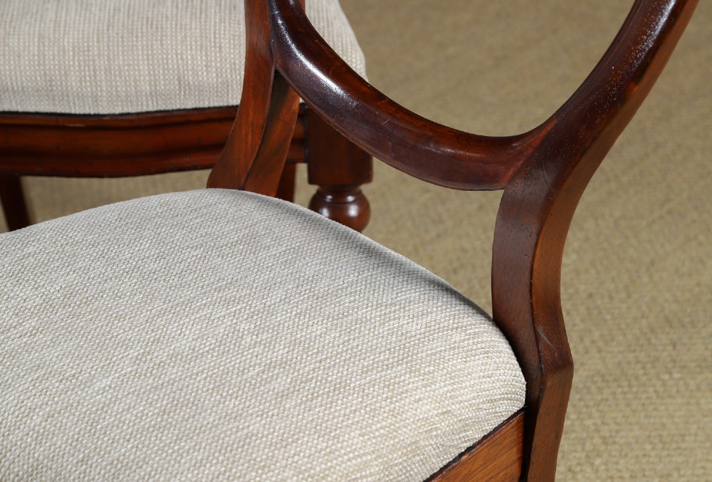 A pair of mid-nineteenth century Victorian mahogany dining chairs featuring balloon back frames, turned front legs, and neutral fabric upholstered seats. View IV