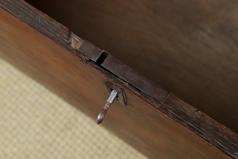 A rectangular dark brown oak six-plank coffer featuring V-cut side legs and iron keyhole escutcheon detail. View XII