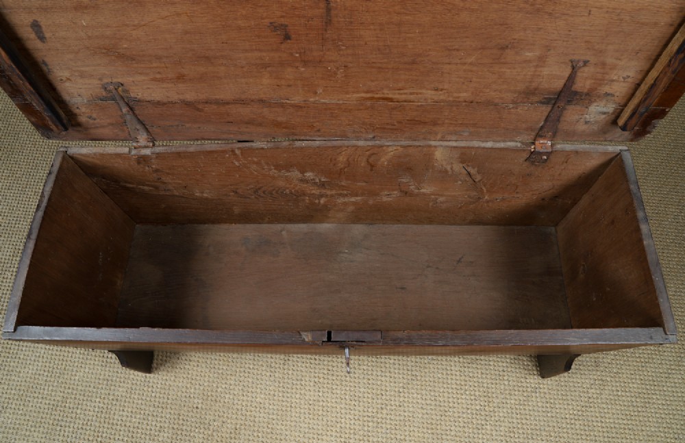A rectangular dark brown oak six-plank coffer featuring V-cut side legs and iron keyhole escutcheon detail. View XIII