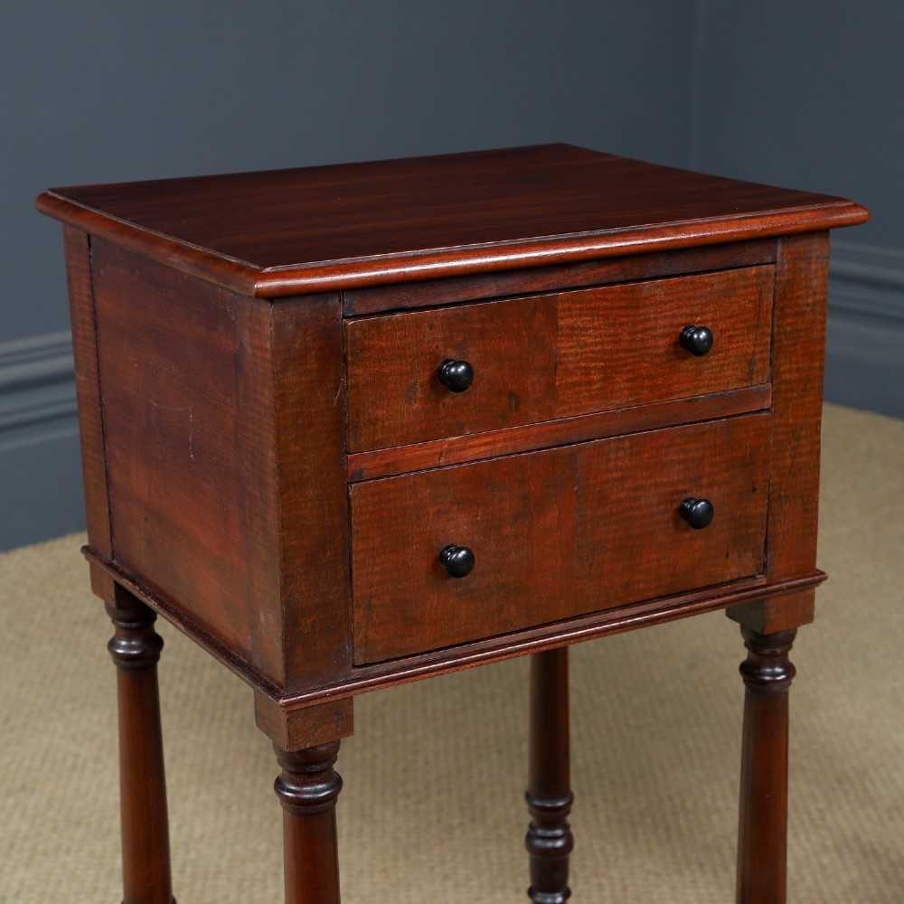 A pair of tall Victorian mahogany bedside tables featuring two small drawers with black knobs, turned legs, and a concave lower shelf. View II