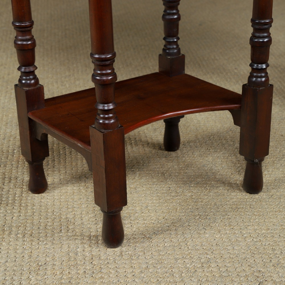 A pair of tall Victorian mahogany bedside tables featuring two small drawers with black knobs, turned legs, and a concave lower shelf. View V