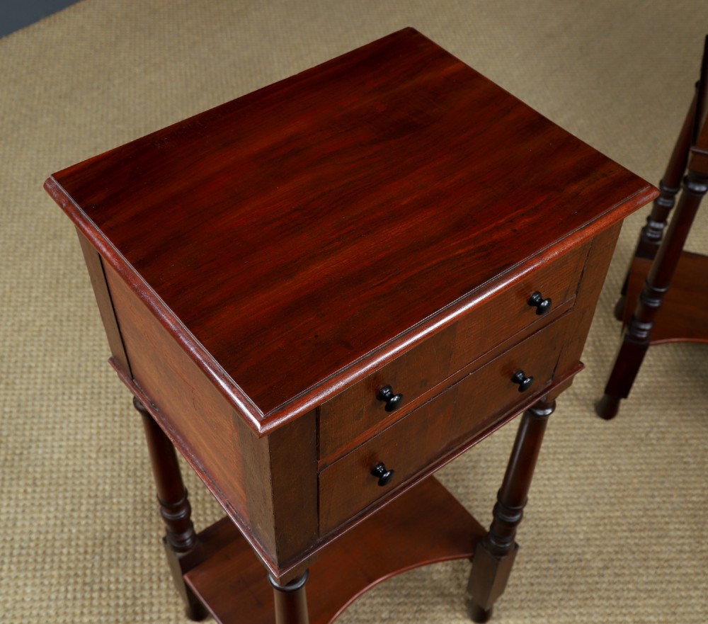 A pair of tall Victorian mahogany bedside tables featuring two small drawers with black knobs, turned legs, and a concave lower shelf. View VI