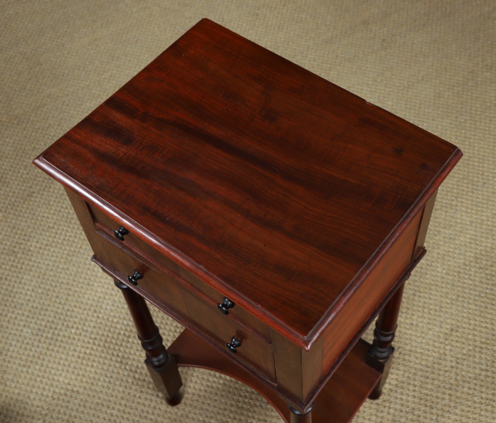 A pair of tall Victorian mahogany bedside tables featuring two small drawers with black knobs, turned legs, and a concave lower shelf. View IX