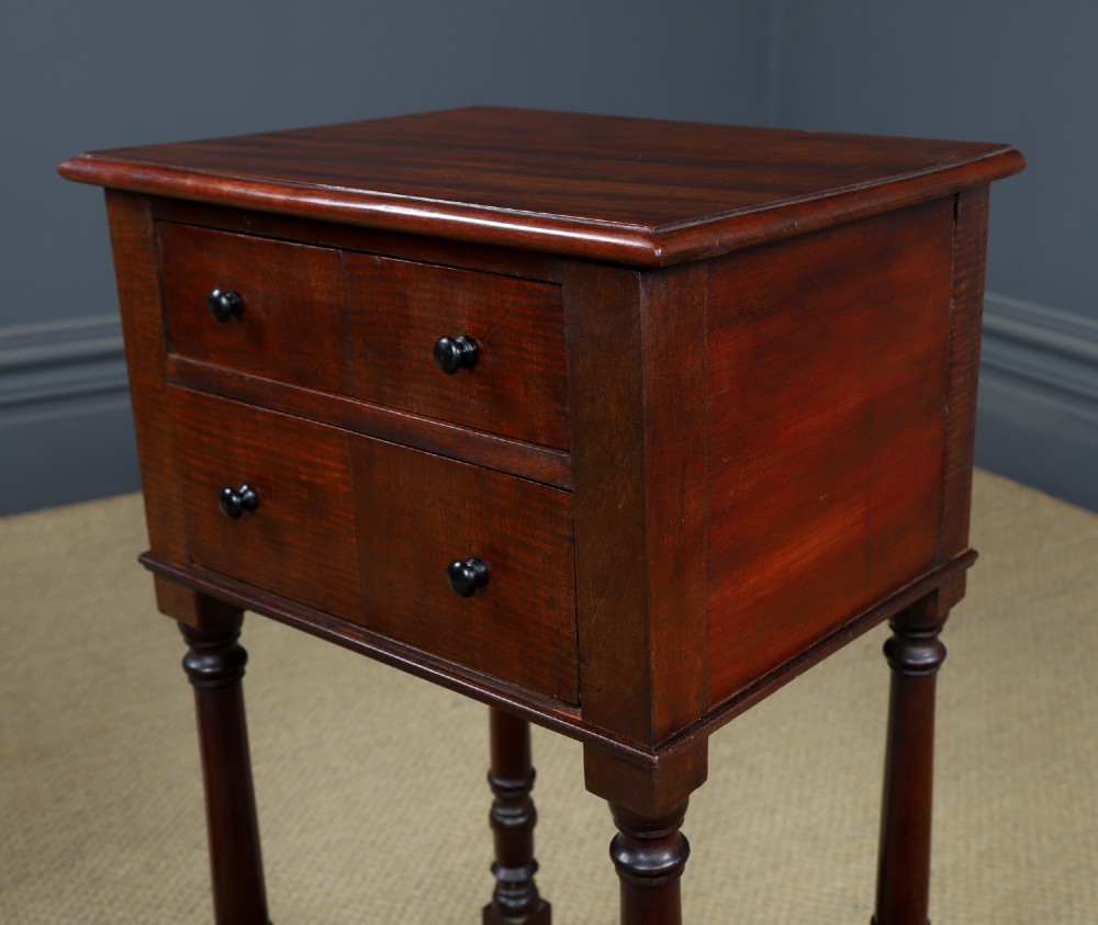 A pair of tall Victorian mahogany bedside tables featuring two small drawers with black knobs, turned legs, and a concave lower shelf. View X