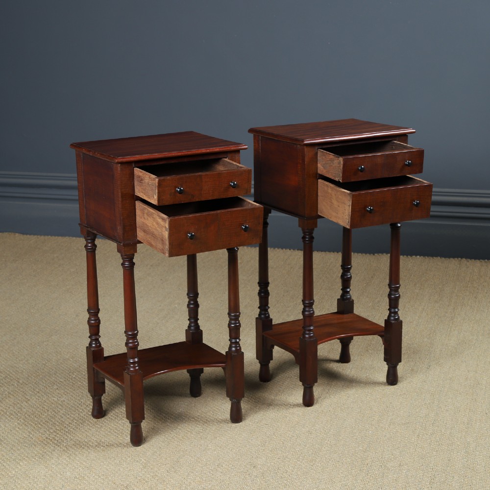 A pair of tall Victorian mahogany bedside tables featuring two small drawers with black knobs, turned legs, and a concave lower shelf. View XIV