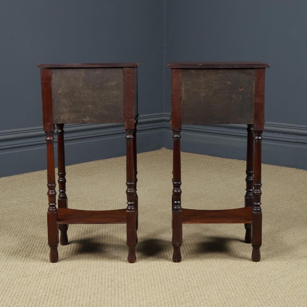 A pair of tall Victorian mahogany bedside tables featuring two small drawers with black knobs, turned legs, and a concave lower shelf. View XV