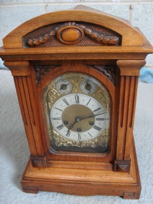 Walnut Carved Cased Mantel Clock with Brass Display
