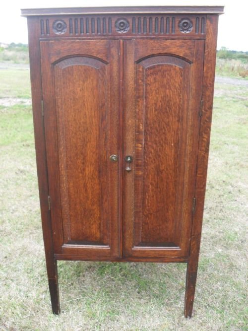 Solid Oak 2 Door Cabinet with Carved Frieze on Tapering Legs