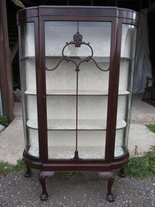 Superb Edwardian Dark Mahogany Bow Sided Display Cabinet with Large Single Door, Nicely Upholstered Back and Shelves Set on Four Carved Legs with Ball and Claw Feet