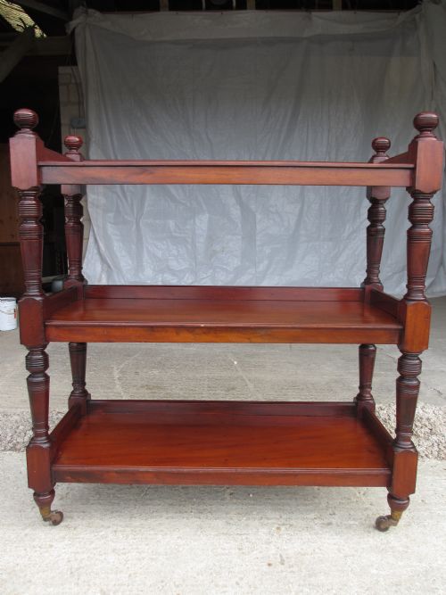 Quality Victorian Mahogany Three Tier Buffet Dumb Waiter with Turned and Block Supports Set on Capped Castors, Gallery Tray Shelves and Turned Knob Finials