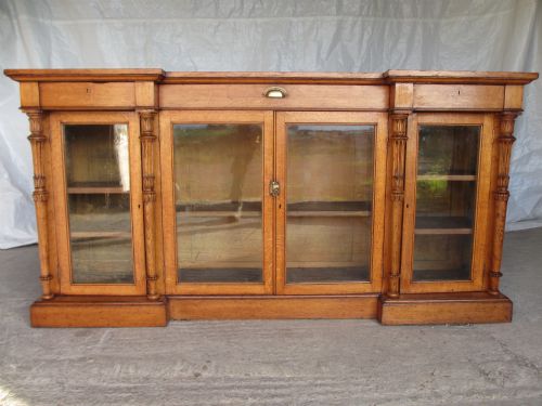 Superb Victorian Golden Oak Inverted Break Front Glazed Bookcase with 3 Frieze Drawers, Turned Carved and Fluted Columns, Glazed Doors Adjustable Shelved Interior on Plinth Base